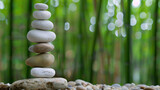 Fototapeta Desenie - Zen stones perfectly balanced, set against the soothing backdrop of a bamboo grove. Wellness Month concept, balance, peace, and meditation.