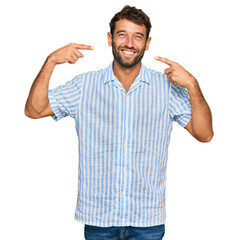 Wall Mural - Handsome young man with beard wearing casual fresh shirt smiling cheerful showing and pointing with fingers teeth and mouth. dental health concept.