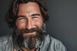 © furyon - charismatic bearded man with friendly smile and confident gaze looking directly at camera engaging portrait photography