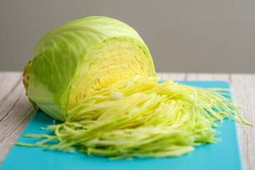 Wall Mural - Culinary creativity: Sliced white cabbage on a cutting board for salad preparation