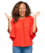 © Krakenimages.com - Middle age hispanic woman wearing casual clothes celebrating victory with happy smile and winner expression with raised hands