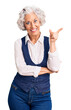 © Krakenimages.com - Senior grey-haired woman wearing casual clothes smiling happy pointing with hand and finger to the side