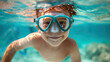 a cheerful boy swimming underwater in a mask. Summer vacation.