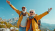 Two happy active seniors having fun at the top of the mountain. Couple of mature people enjoying and having fun in vacations. Traveling lifestyle
