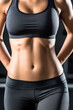 © Ocharonata - female flat athletic belly with abs in black sportswear on gym background