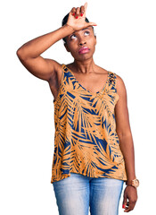 Poster - Young african american woman wearing casual clothes making fun of people with fingers on forehead doing loser gesture mocking and insulting.