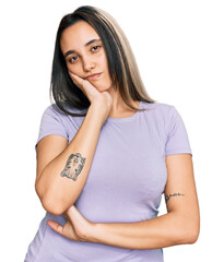 Wall Mural - Young hispanic woman wearing casual clothes thinking looking tired and bored with depression problems with crossed arms.