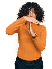 Poster - Young hispanic woman wearing casual clothes doing time out gesture with hands, frustrated and serious face