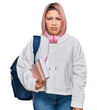 © Krakenimages.com - Hispanic woman with pink hair wearing student backpack and headphones skeptic and nervous, frowning upset because of problem. negative person.