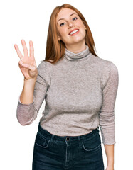 Wall Mural - Young irish woman wearing casual clothes showing and pointing up with fingers number three while smiling confident and happy.