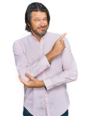 Poster - Middle age handsome man wearing business shirt with a big smile on face, pointing with hand and finger to the side looking at the camera.