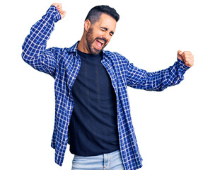 Sticker - Young hispanic man wearing casual clothes dancing happy and cheerful, smiling moving casual and confident listening to music