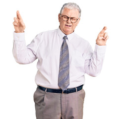 Canvas Print - Senior grey-haired man wearing business clothes gesturing finger crossed smiling with hope and eyes closed. luck and superstitious concept.