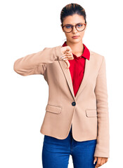 Canvas Print - Young beautiful woman wearing business shirt and glasses looking unhappy and angry showing rejection and negative with thumbs down gesture. bad expression.