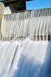 © maxdigi - Dam Spillway Water Rushing vertical. A dam spillway as the water pours over the top