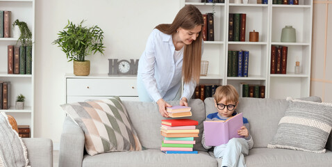 Poster - Cute little boy and his mother with different books at home