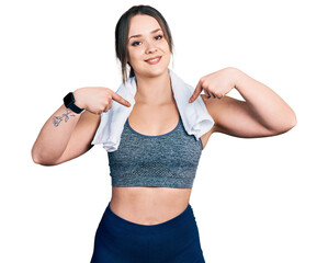 Wall Mural - Young hispanic girl wearing sportswear and towel looking confident with smile on face, pointing oneself with fingers proud and happy.