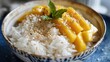 Mouthwatering mango sticky rice served with coconut cream and sesame seeds