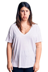 Canvas Print - Young beautiful brunette woman wearing casual t-shirt depressed and worry for distress, crying angry and afraid. sad expression.