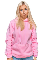 Wall Mural - Young blonde woman wearing casual sweatshirt skeptic and nervous, frowning upset because of problem. negative person.