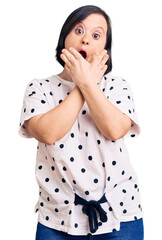 Poster - Brunette woman with down syndrome wearing casual clothes shocked covering mouth with hands for mistake. secret concept.