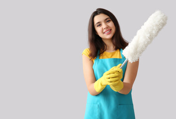 Sticker - Young woman with pp-duster on grey background