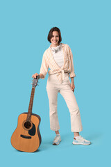 Sticker - Young woman with headphones and guitar on blue background