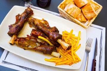 Wall Mural - Caldereta de cordero - lamb bone with french fries