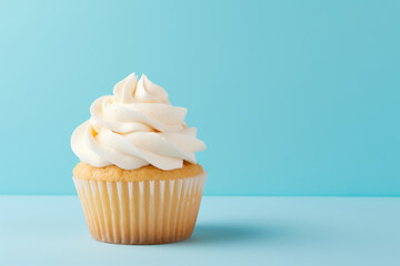 Wall Mural - Simple birthday cupcake on a solid light blue background with empty space on the left