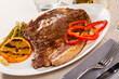 Delicious grilled beef entrecote served with vegetable garnish of asparagus and grilled orange