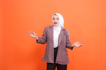 Business, finance and advertising, businesswoman concept. Asian businesswoman shocked hand sign showing don't know, how come, how can this happen isolated orange indoor studio background