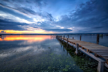 Wall Mural - Serene lake sunset with wooden pier