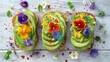 Gourmet avocado toast garnished with edible flowers and spices on a white rustic wooden background.