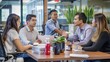 © Phoophinyo - A group of young professionals engages in lively discussion about business strategies during meeting in office. Their energy is palpable as they brainstorm ideas and collaborate towards common goals.