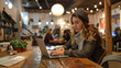 © Old Man Stocker - Young Woman Freelancing at Cozy Cafe. Young woman focused on her laptop while working in a cozy, well-lit cafe, surrounded by a casual, creative atmosphere.