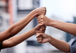 © peopleimages.com - Outdoor, meeting or business people with fist in stack for mission goal, collaboration or teamwork. Cooperation, community project or hands of employees in city with support, solidarity or motivation