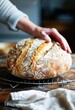 Artisan Baker Holding Freshly Baked Sourdough Bread in a Rustic Kitchen