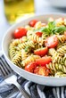 Fresh Pesto Pasta Salad With Cherry Tomatoes and Basil in Natural Daylight