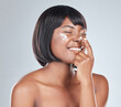 © peopleimages.com - Happy, black woman and skincare with cream for facial treatment or moisturizer on a white studio background. African, female person or young model with smile for lotion, cosmetics or healthy skin