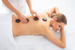 © Acronym - Young woman getting massaging treatment over white. Spa, healthcare and recreation concept.