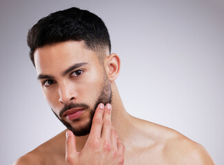 Canvas Print - Portrait, skincare and natural beauty of man grooming in studio isolated on white background. Dermatology, touch face and serious model in cosmetics for health, wellness or clean facial aesthetic