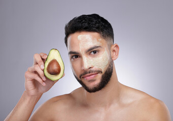 Poster - Skincare, portrait and man with avocado mask, confidence and vitamin c treatment in studio. Cosmetics, facial health and happy male model with fruit detox, dermatology or grooming on grey background