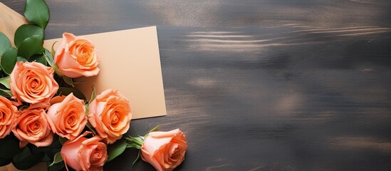 Wall Mural - The homemade flat lay on the table features a creative mock up layout adorned with roses There is copy space available and an empty sheet of paper accompanied by a mockup card and an orange rose