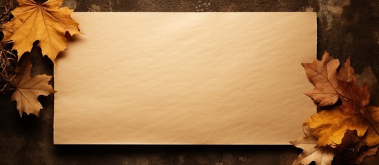 Poster - Top view of blank memo paper on brown kraft paper background adorned with dry autumn leaves Perfect for adding text or images. Creative banner. Copyspace image