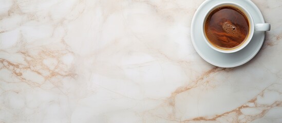 Poster - A copy space image of a coffee cup can be seen from a top view position on a marble table background