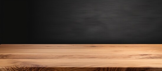 Poster - A copy space image showcasing the perspective view of a wooden table top corner on a black background complete with a clipping path and a template for mock up purposes