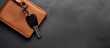 © HN Works - Dark grey background with a male leather wallet and car key providing ample copy space for the image