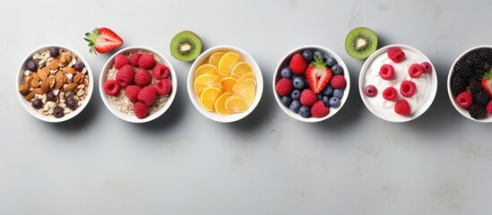 Aufkleber - Top view of a collection of bowls filled with granola yogurt and berries placed on a grey background A visually appealing copy space image illustrating a variety of breakfast options to choose from