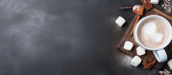 Aufkleber - A cozy winter themed cup filled with hot cocoa or chocolate adorned with marshmallows and cinnamon placed on a grey background The image is taken from a top down view leaving ample space for addition