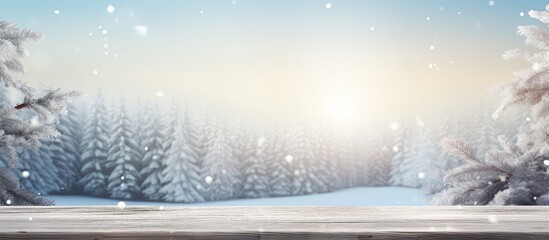 Poster - A wintry Christmas background featuring a snowy landscape with fir branches The wooden table is placed in the foreground with a blue tint and sunlight enhancing the image Plenty of copy space is avai